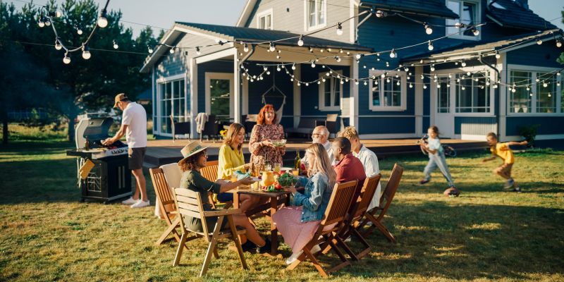 home insurance coverage over family home with family generations having a cookout in backyard